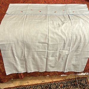 Blue crib cotton bedsheet with hand embroidering.